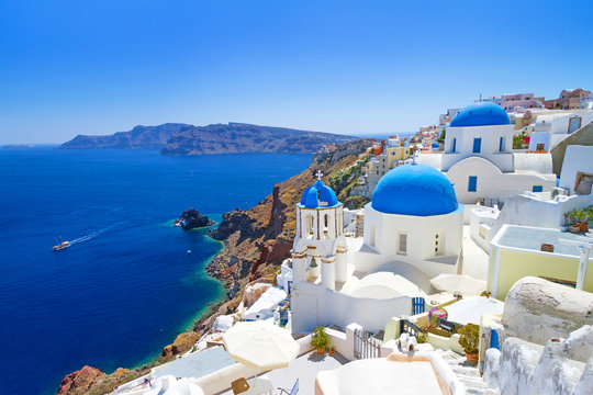 Greece travel destination with whitewashed buildings, blue domes, and scenic coastline