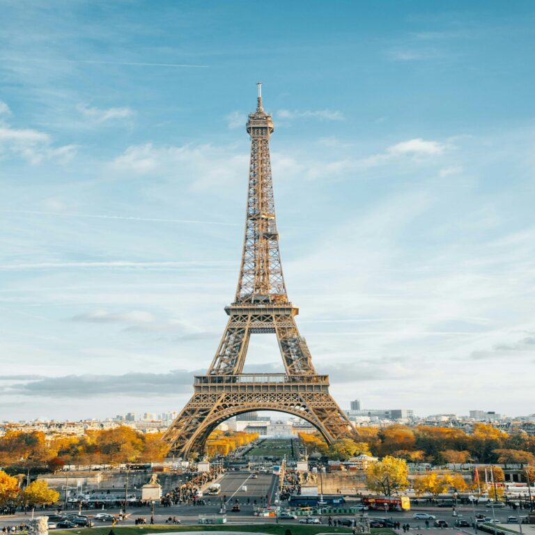 Paris skyline featuring Eiffel Tower and Seine River at sunset